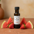 Watermelon Strawberry White Balsamic Vinegar bottle with watermelon and strawberries on terracotta surface